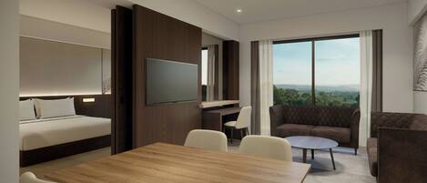 Una habitación de hotel moderna con cama, televisión de pantalla plana, zona de comedor y sofá.