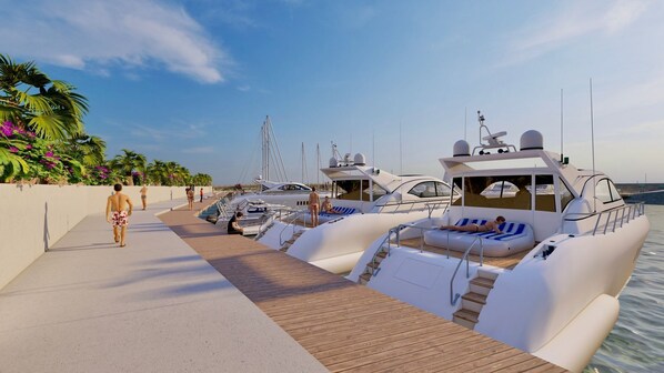 A marina with several yachts docked, a wooden walkway, and a few people walking. - Portemilio Hotel And Resort (Jounieh)