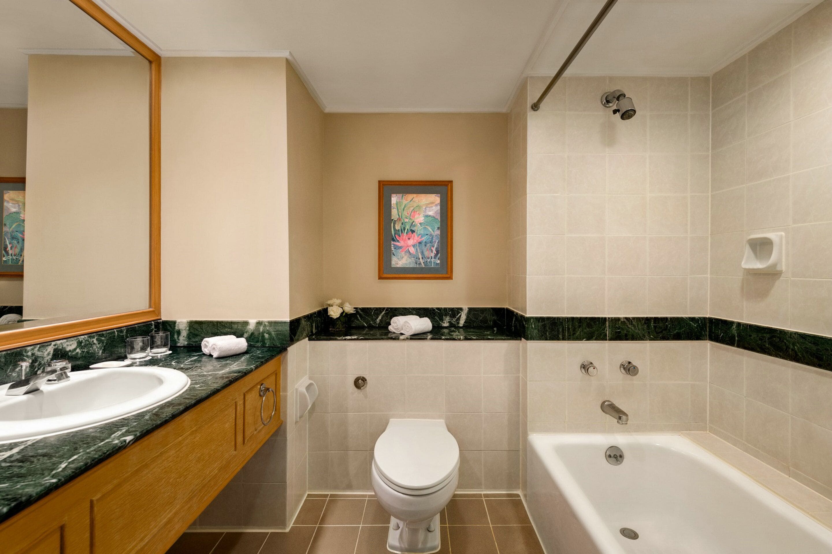 A bathroom with a sink, toilet, and bathtub.