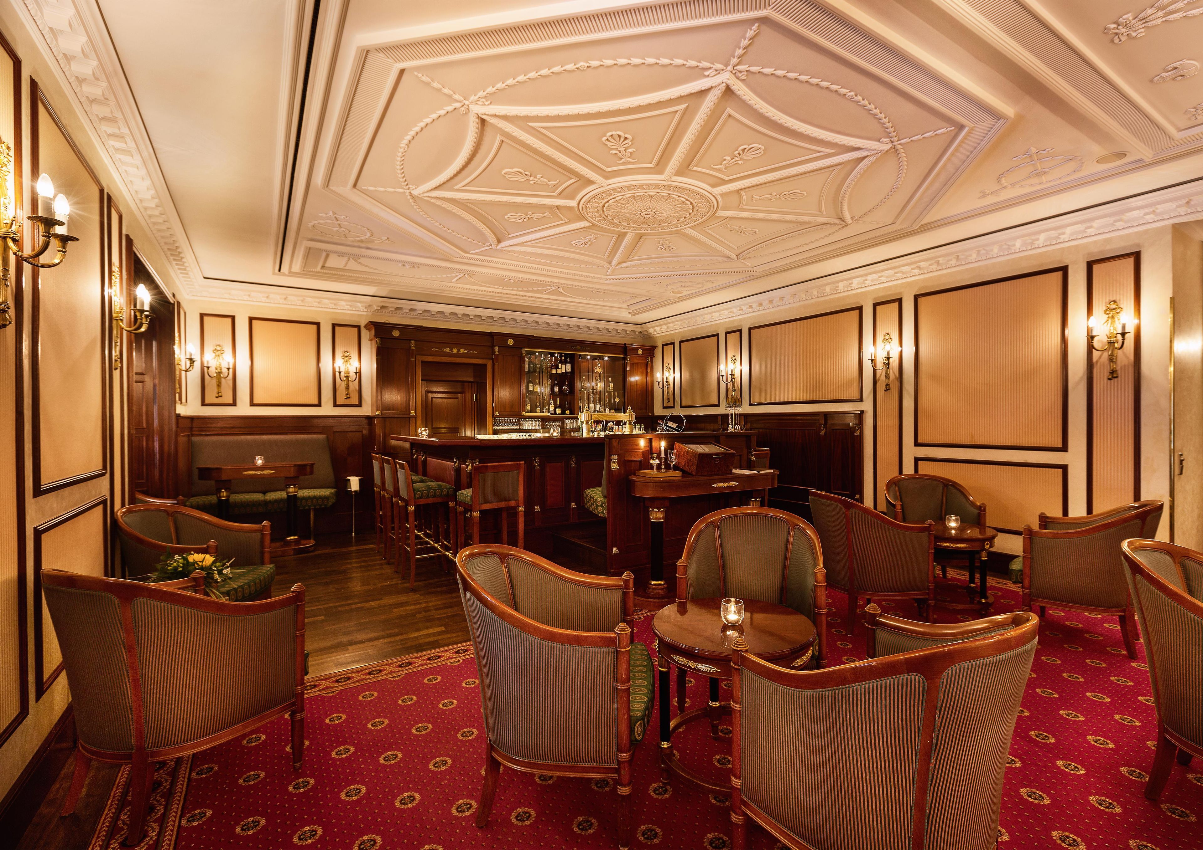 A bar area with wooden furniture and a patterned carpet.