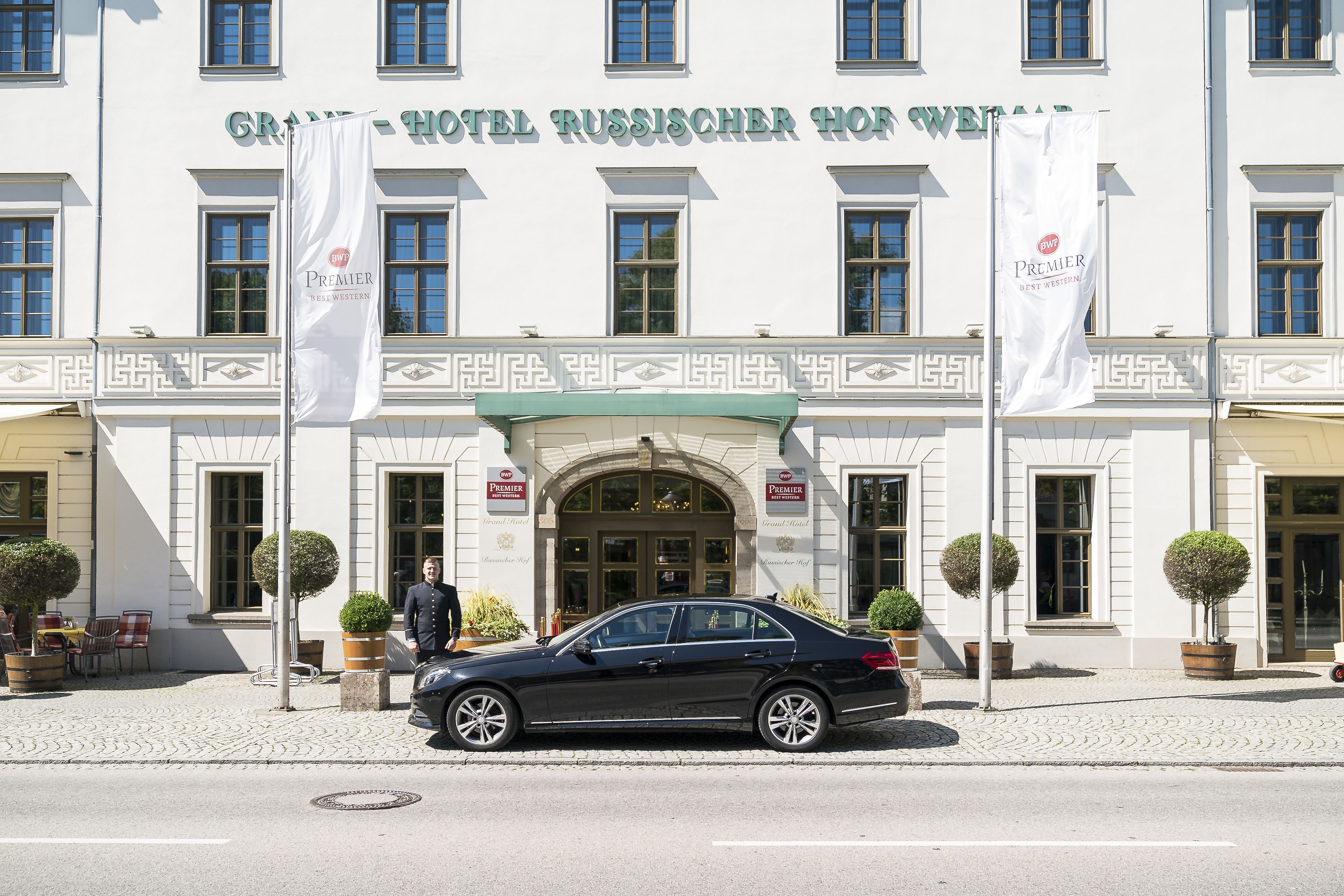 A hotel facade with a classic architectural style, featuring a prominent entrance and multiple windows.