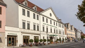 A historic building with a café and a shop on the ground floor, featuring a classic European architectural style. - Best Western Premier Grand Hotel Russischer Hof (Weimar)