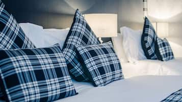 Restful haven with a neatly made bed and stylish lamp.