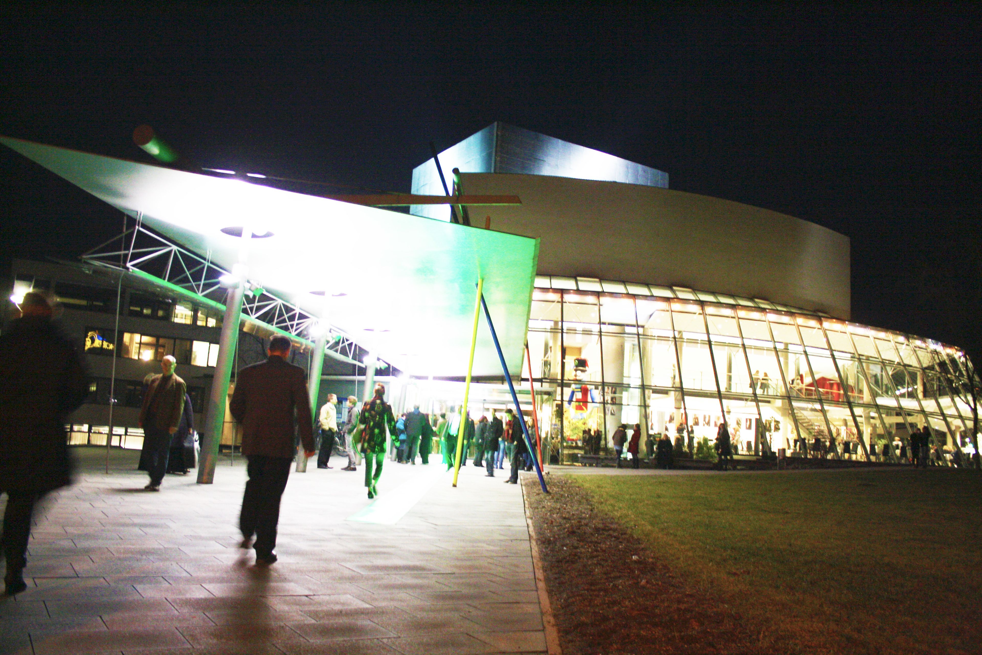 A modern building with a glass facade and a flat roof.