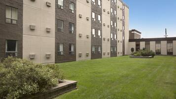 Stunning multi-story building with a well-manicured lawn and garden.