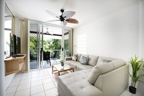 One-Bedroom King with Sofa Bed - Top Floor | Living area | 40-inch Smart TV with digital channels, TV, books - Golden Sands Beachfront Apartment Resort (Yorkeys Knob)