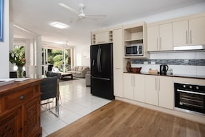 One-Bedroom King Apartment - Pool/Garden View | Private kitchen | Full-size fridge, microwave, stovetop, coffee/tea maker