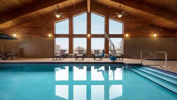 Relax by the pool surrounded by natural light and comfortable lounge chairs.