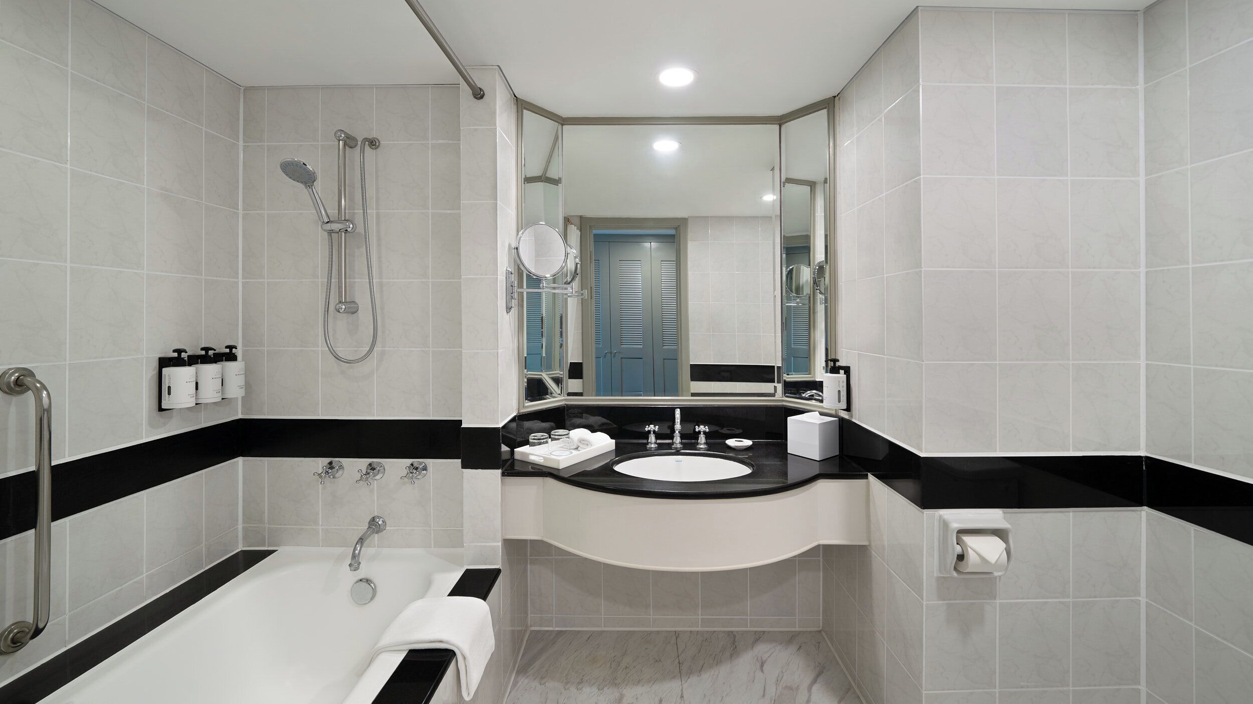 A modern bathroom with a bathtub, a sink, and a shower.
