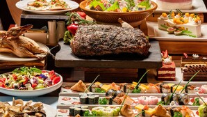 A variety of food items including sushi, a roasted pig, and a dessert cake. - Marco Polo Xiamen (Xiamen)