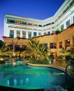 A hotel with a large pool, multiple balconies, and lush landscaping. - ITC Kakatiya, a Luxury Collection Hotel, Hyderabad (Hyderabad)