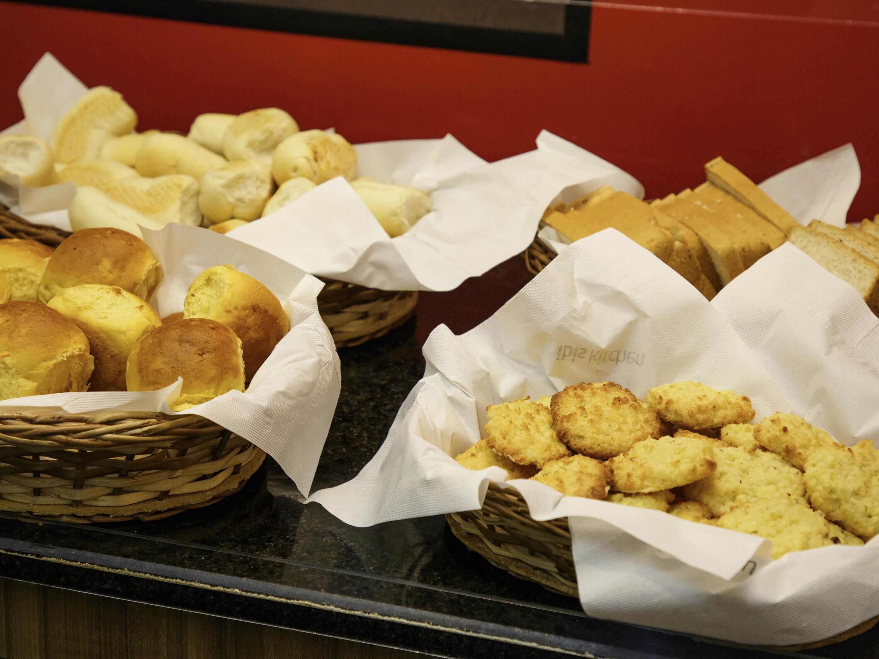 Baskets of bread on a counter.
