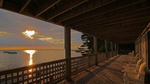 A wooden deck with a view of the sunset over the water. - The Inn At Corolla Light (Corolla)