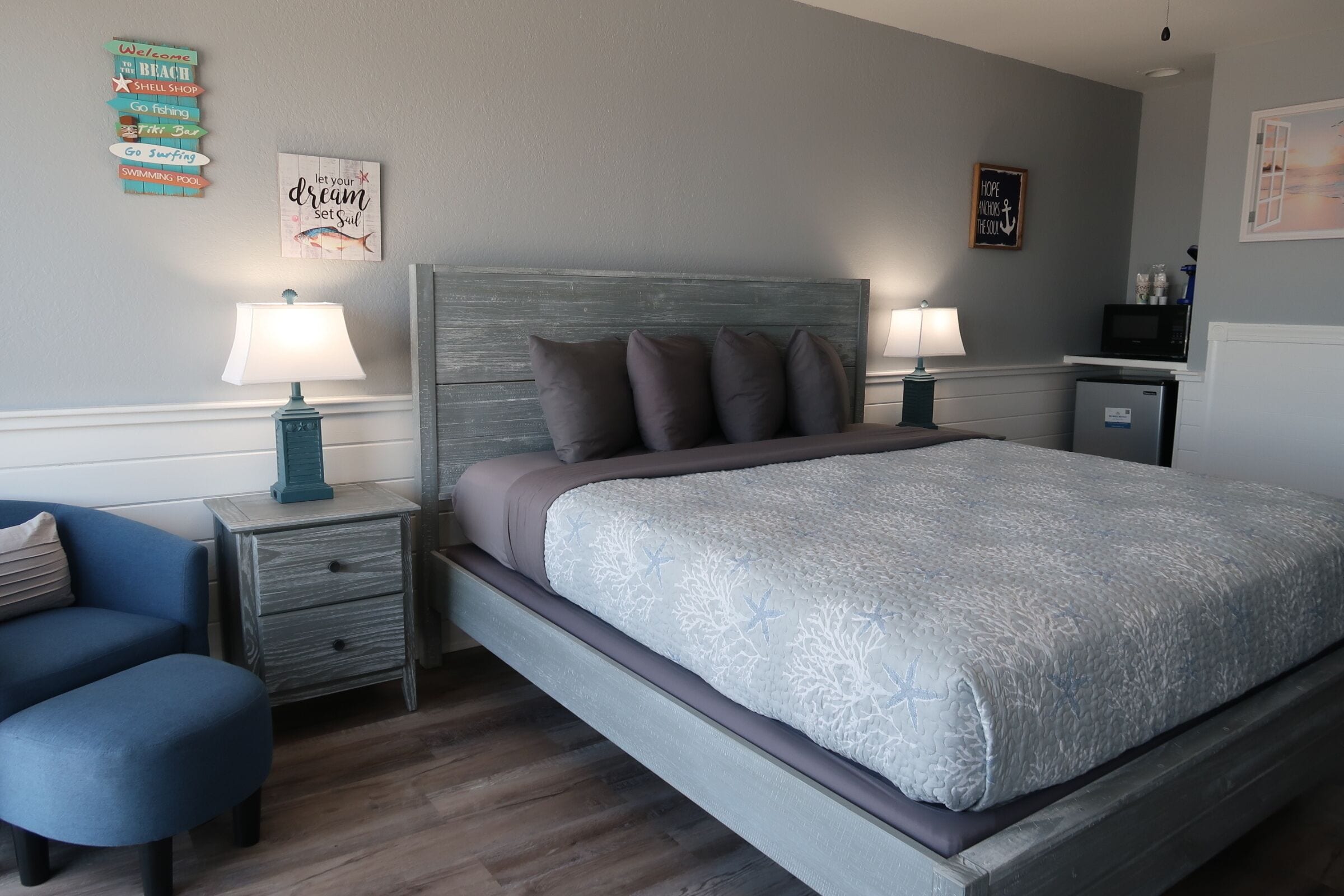 Ein Schlafzimmer mit einem Bett, zwei Nachttischen mit Lampen, einem kleinen Schreibtisch und einem Stuhl.