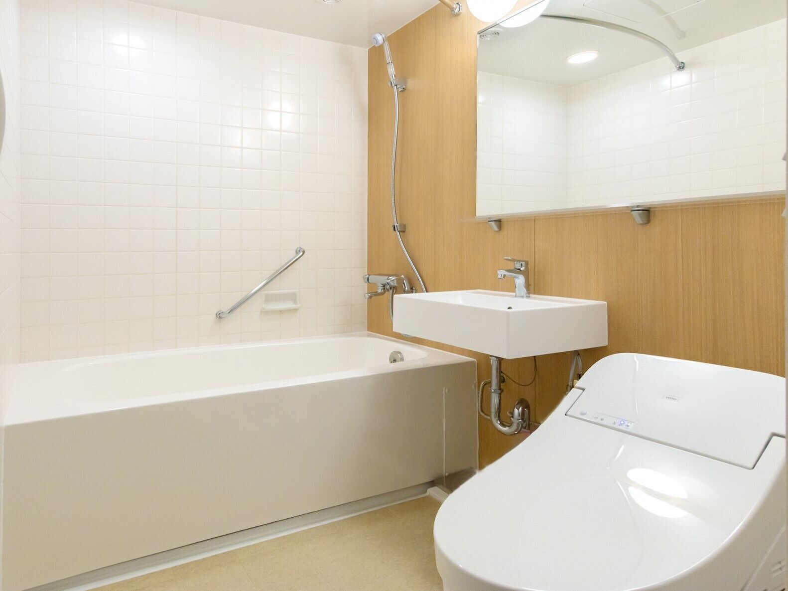 A modern bathroom with a bathtub, a sink, and a toilet.