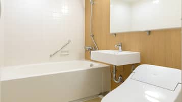 A modern bathroom with a bathtub, a sink, and a toilet.