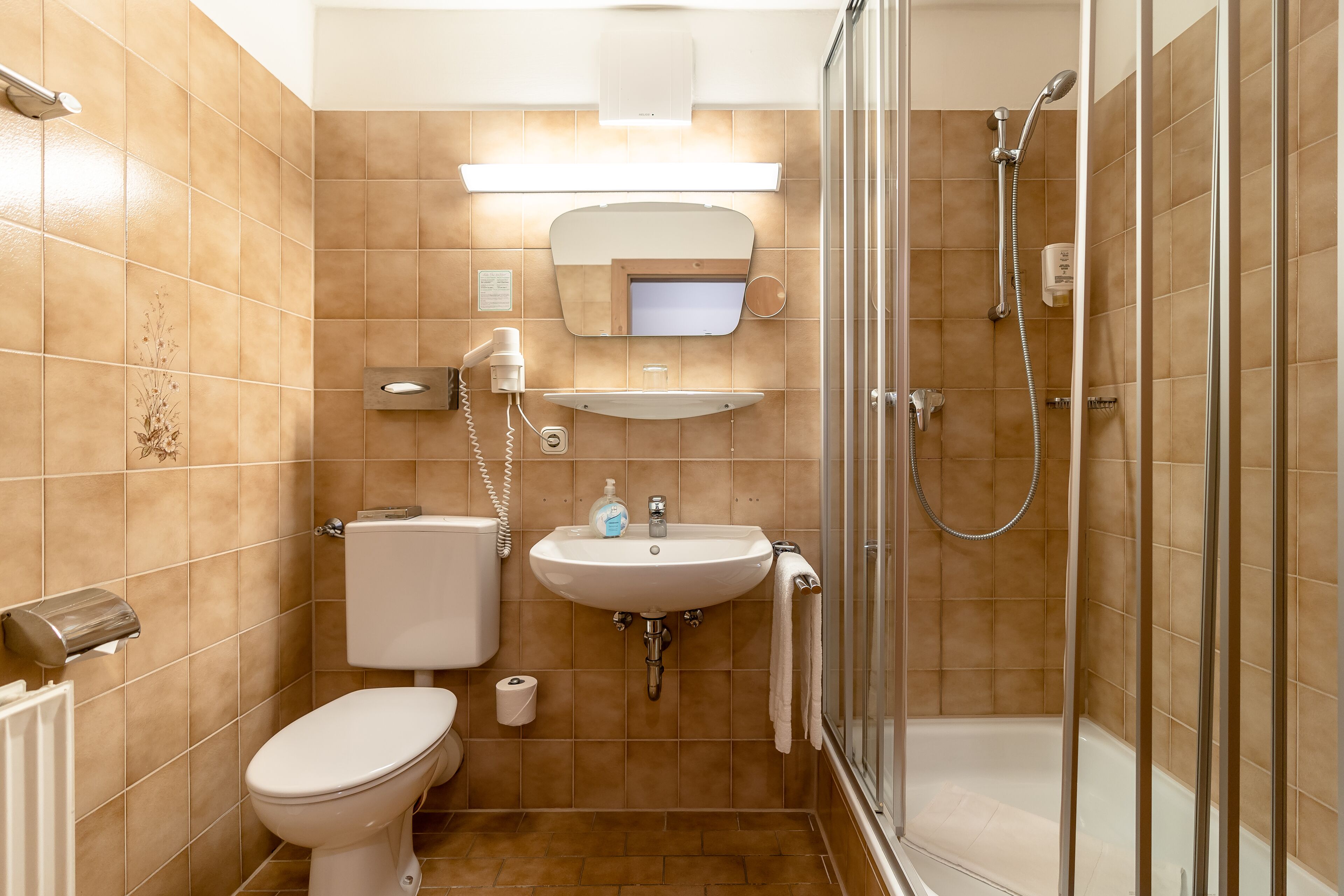 Ein Badezimmer mit Toilette, Waschbecken und Dusche.
