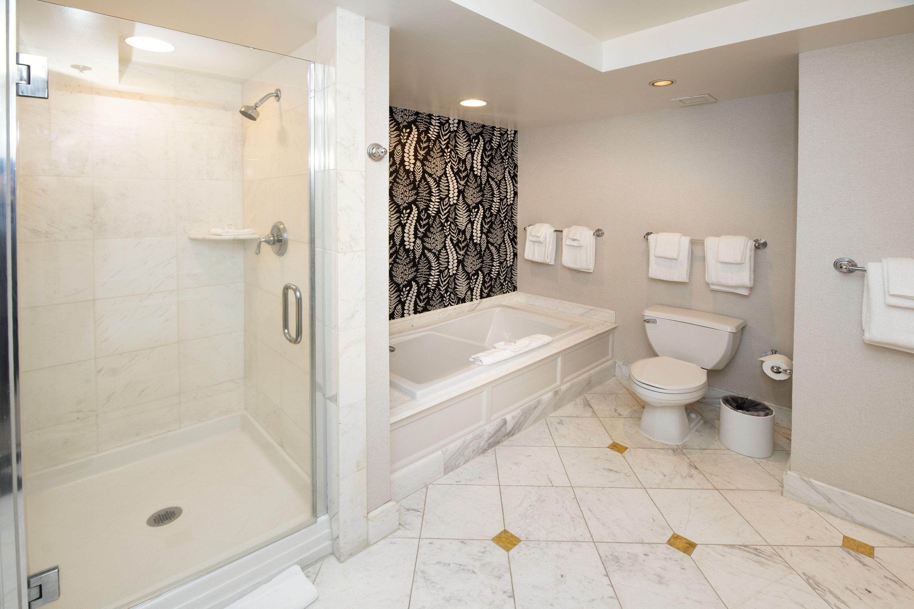 Un bagno moderno con doccia vetrata, vasca da bagno freestanding e servizi igienici.