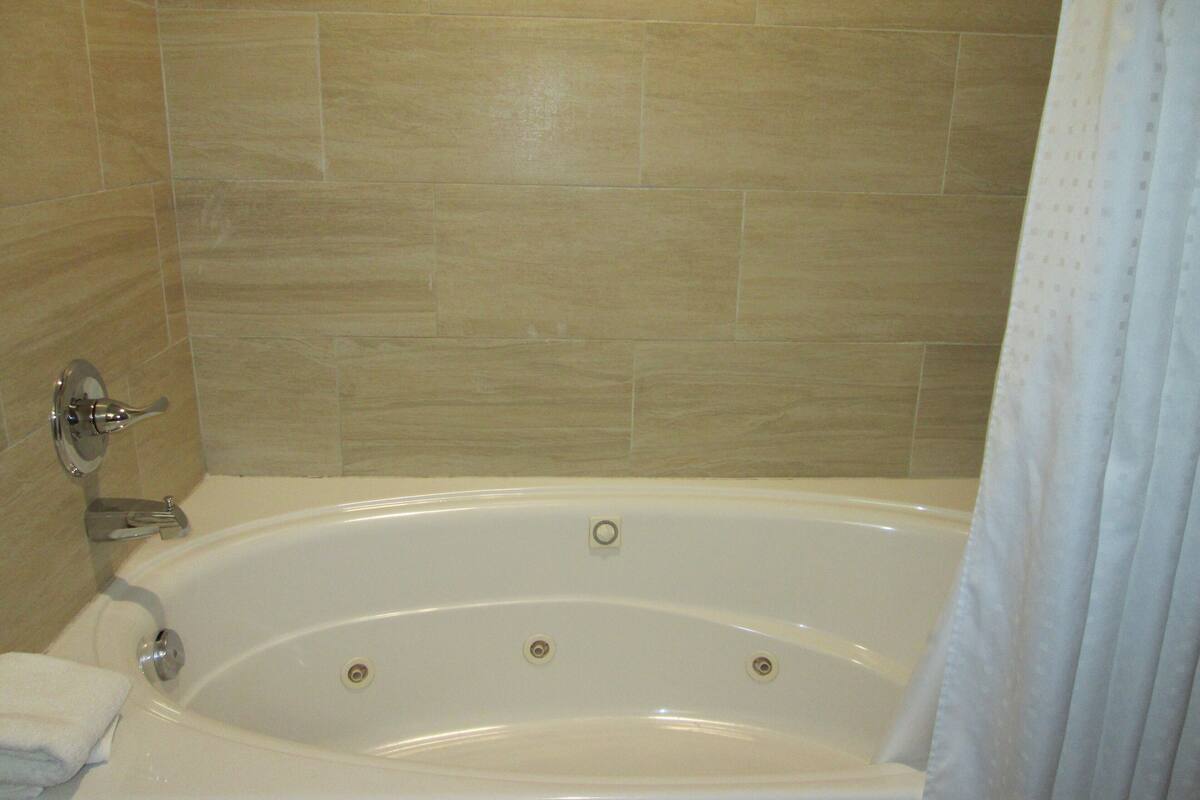 A bathroom with a bathtub, a shower, and a toilet.