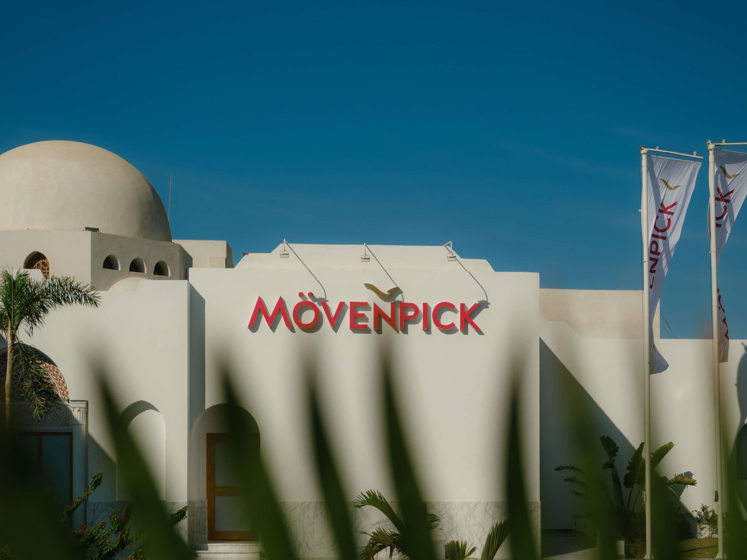 A building with a dome and the text 'MÖVENPICK' on the facade.