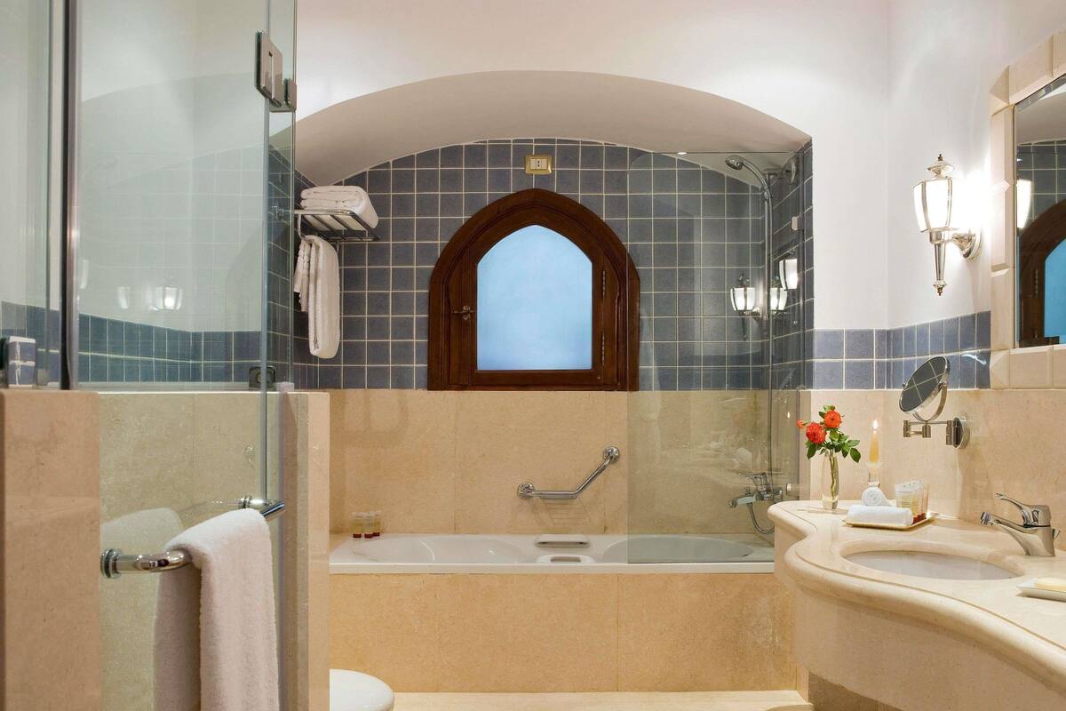 A bathroom with a bathtub, a sink, a toilet, and a shower.