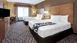 A hotel room with two beds, a TV, a desk, and a large window with curtains. - La Quinta Inn & Suites by Wyndham Coeur d`Alene (Coeur d'Alene)