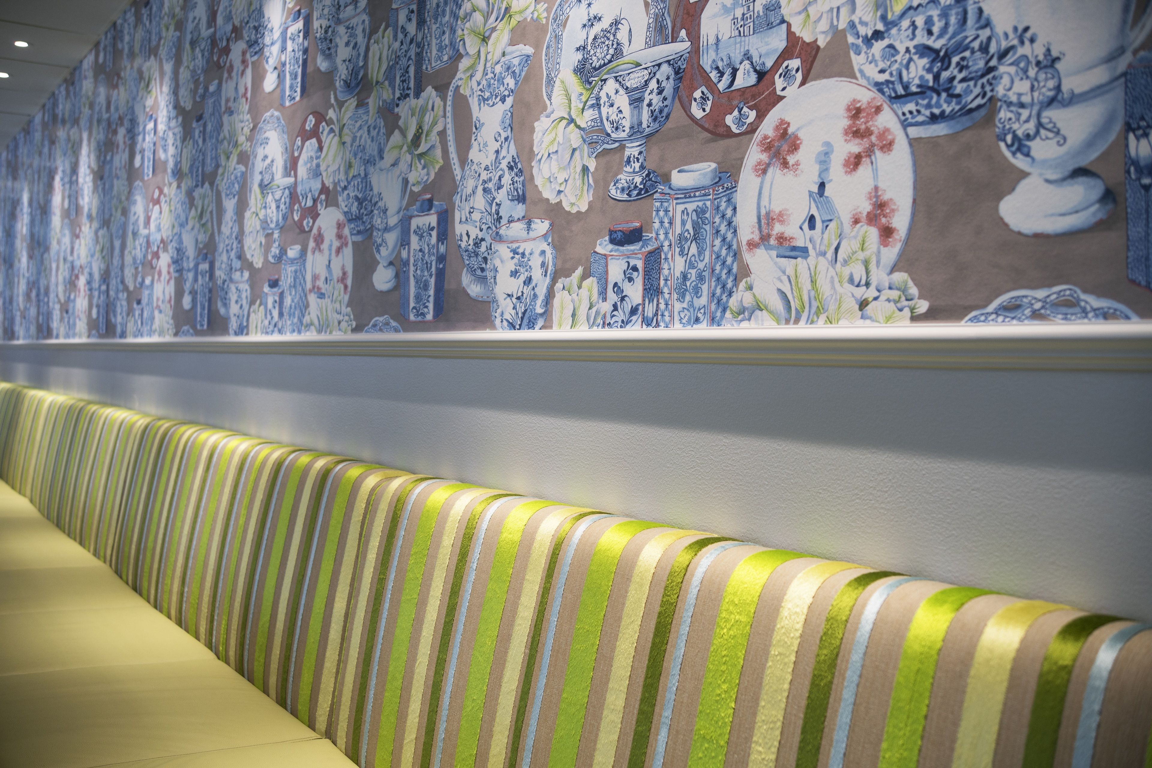 A wall with a blue and white ceramic pattern.