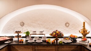 A buffet setup with various food items and a decorative centerpiece. - Relais & Châteaux Hotel Tennerhof (Kitzbuhel)