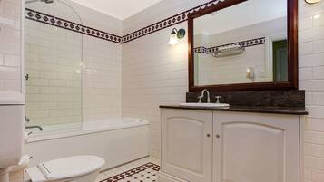 A bathroom with a toilet, sink, and bathtub.