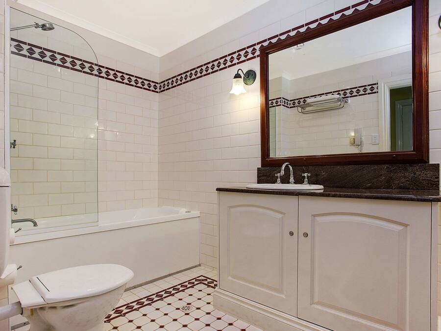 A bathroom with a toilet, sink, and bathtub.