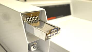 A close-up of a coin slot with a $1.50 denomination.
