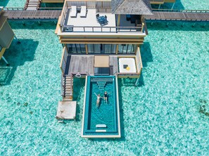 An overwater bungalows with a swimming pool, wooden deck, and lounge area. - Angsana Velavaru - Free return Seaplane Transfers (Velavaru)