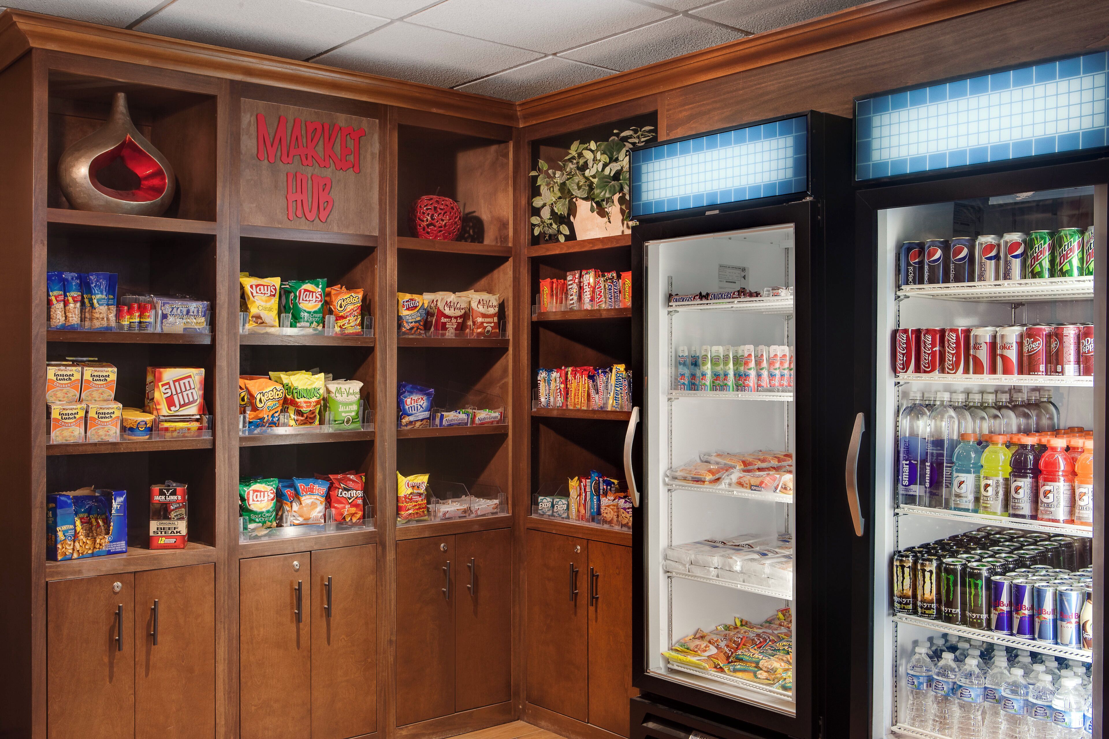 A vending machine area with snacks and drinks, including chips, sodas, and energy drinks.