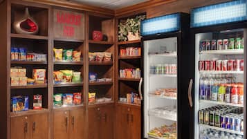 A vending machine area with snacks and drinks, including chips, sodas, and energy drinks.