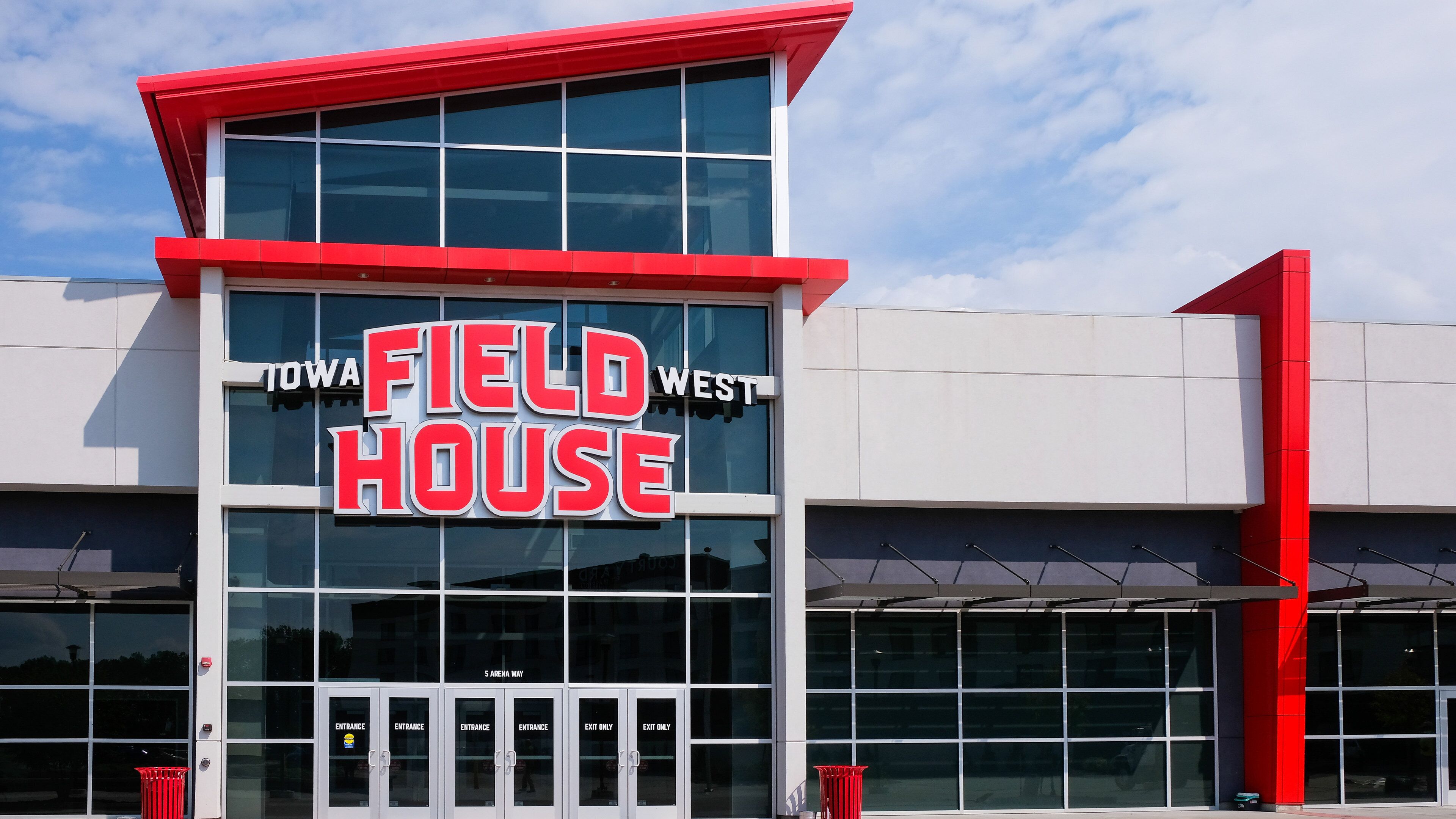 A building with a sign reading "IOWA FIELD HOUSE" and a "5 ARENA WAY" entrance.
