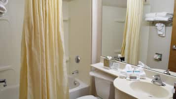 A bathroom with a bathtub, toilet, and sink.