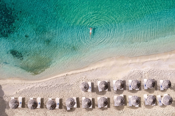 On the beach, sun-loungers, beach umbrellas, beach towels