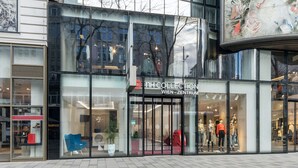 A modern building with large glass windows and a sign for 'NH COLLECTION WIEN - ZENTRUM'. - NH Collection Wien Zentrum (Vienna)