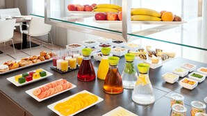 A breakfast buffet with various food items and beverages. - NH Collection Wien Zentrum (Vienna)