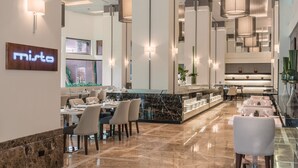 A modern restaurant with marble flooring, high ceilings, and pendant lighting. - Seda Ayala Center Cebu City (Cebu City)
