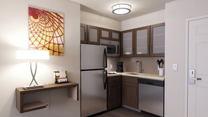 Una cocina moderna con armarios de madera, un refrigerador de acero inoxidable, un microondas y una cafetera.