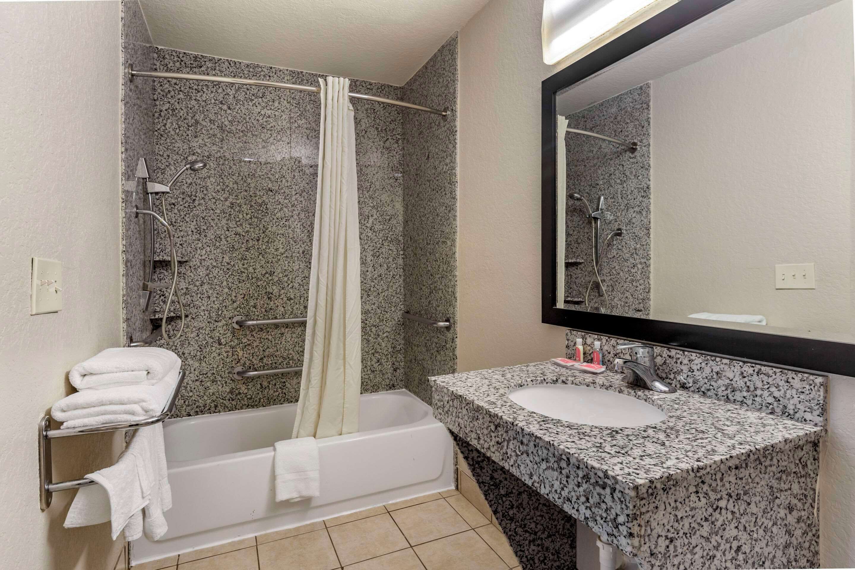 A bathroom with a bathtub, a sink, and a shower.