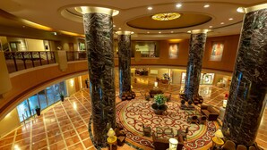 A spacious lobby with marble columns, a central seating area, and a high ceiling with recessed lighting. - Hotel Okura Fukuoka (Fukuoka)