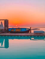 Una piscina al aire libre, sombrillas, tumbonas