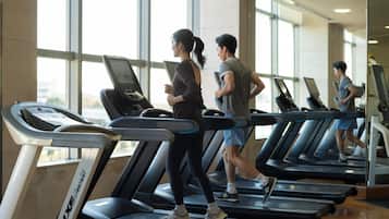 A gym with treadmills, large windows, and a modern interior.