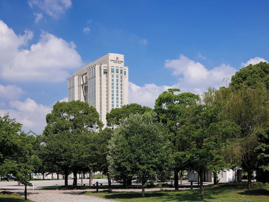 A tall building with a sign reading 'Grand Nikkos.'