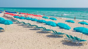 A beach with rows of sun loungers and umbrellas. - Best Western Plus Atlantic Beach Resort (Miami Beach)