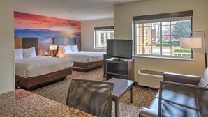 A hotel room with two beds, a television, a desk, and a chair. - LeConte Hotel & Convention Center, an Ascend Collection Hotel (Pigeon Forge)