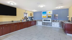 A spacious kitchen with a large island, built-in appliances, and a flat-screen TV. - Days Inn by Wyndham Holladay (Holladay)