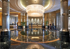 A lobby with a central chandelier, marble flooring with geometric patterns, and a reception desk. - Mandarin Oriental, Kuala Lumpur (Kuala Lumpur)
